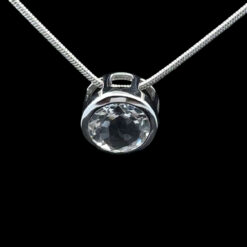 Faceted round rock crystal and rhodium-plated silver pendant