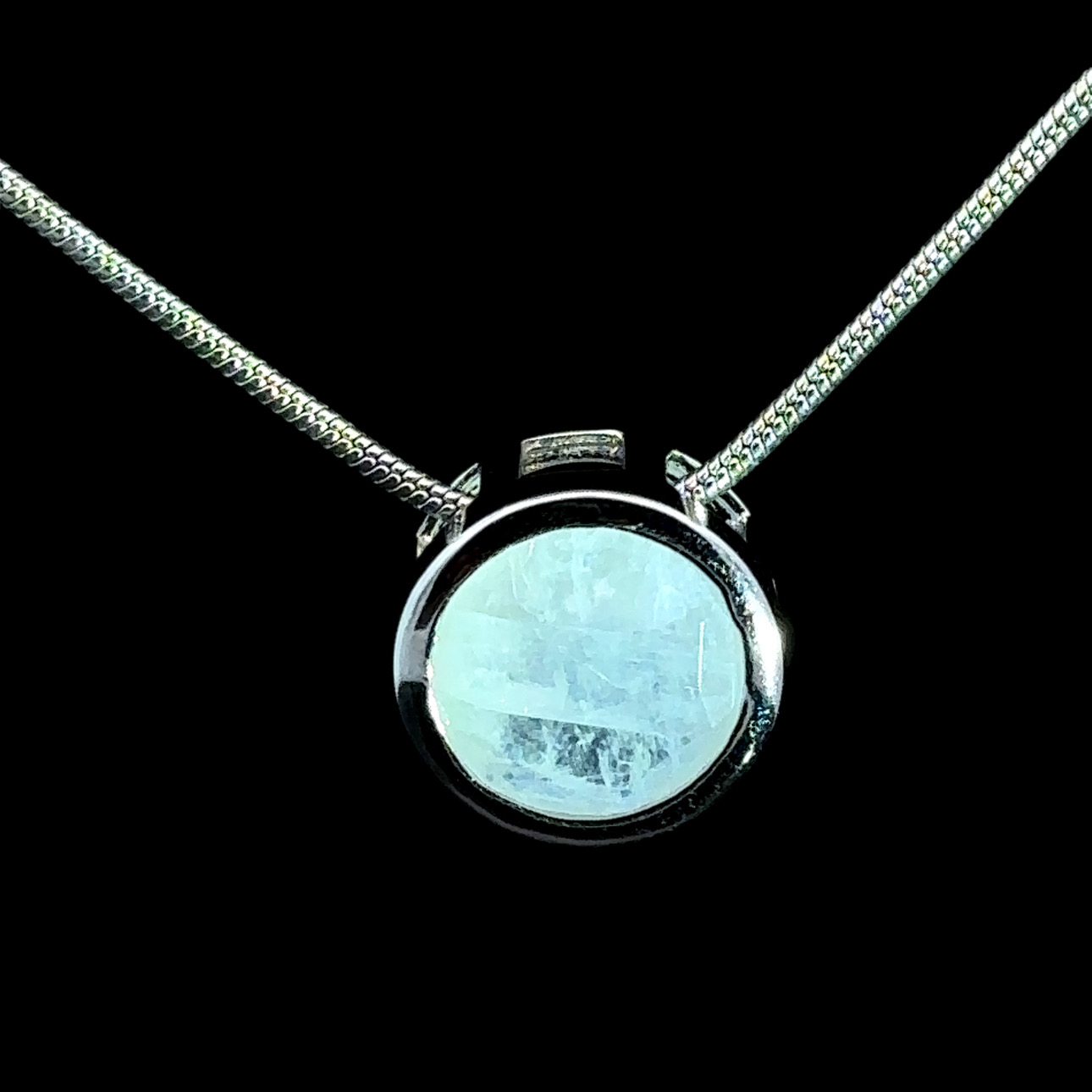 Faceted round moonstone and rhodium-plated silver pendant